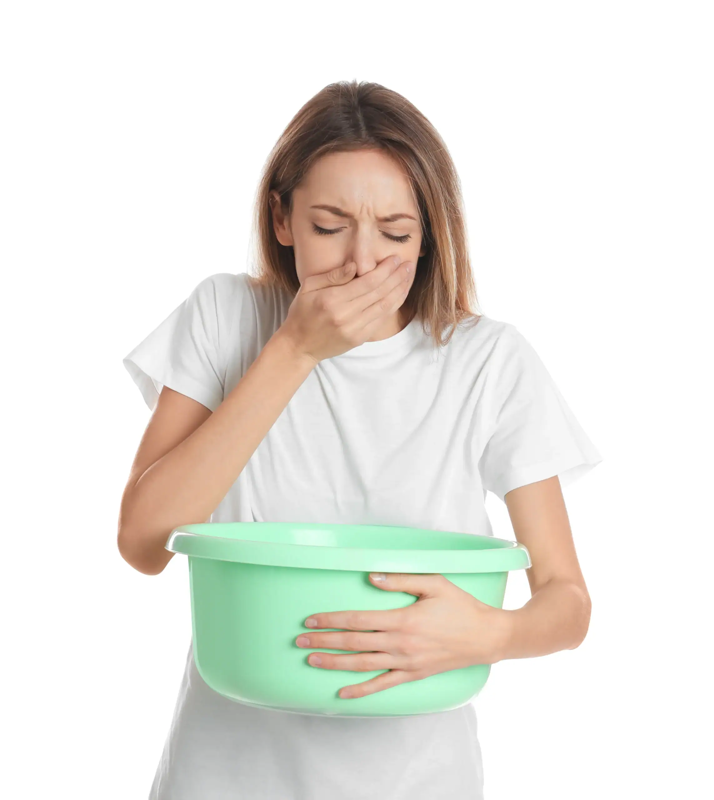 A woman in a white t-shirt holds a green plastic basin and covers her mouth with her hand, appearing to feel nauseous. This image relates to challenges addressed in OCD Therapy Texas and Minnesota. The background is plain white.